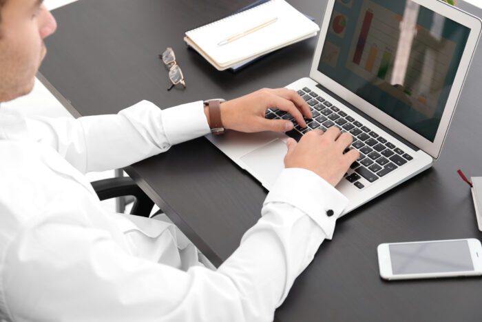 Marketing,Manager,Using,Laptop,At,Table,In,Office Marketing,Manager,Using,Laptop,At,Table,In,Office